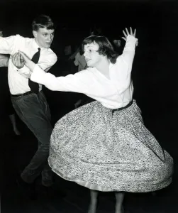 Fifties dancing - Skirt flared out as girl is spun around by her partner at the dance Fifties dancing - Skirt flared out as girl is spun around by her partner at the dance