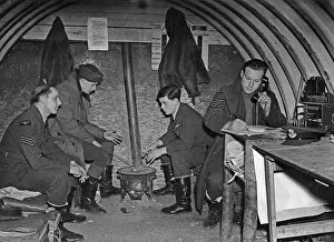 01256 Gallery: Fighter pilots of 73 Squadron RAF warm their hands on a brazier in their underground Duty