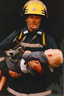 Images Dated 1st June 1995: A firefighter rescus a young boy from a fire 01 / 06 / 95 circa - posed by models