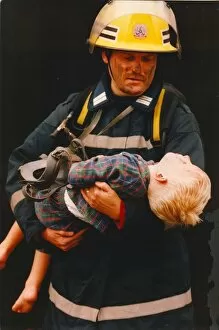 Images Dated 1st June 1995: A firefighter rescus a young boy from a fire 01 / 06 / 95 circa - posed by models