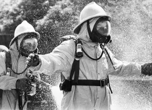 00074 Gallery: Firefighters wearing protective suits fought a blaze in an asbestos unit at Poter Limited