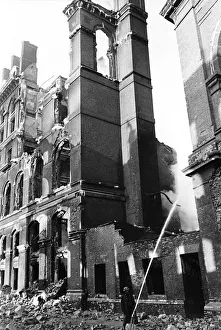 A fireman hoses down smoking remains of a building in Southwark London after an air raid A fireman hoses down smoking remains of a building in Southwark London after an air raid