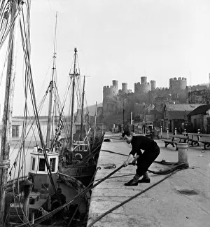 Fishermen ties up his fishing boats at Conway Castle. March 1953 D1229 Fishermen ties up his fishing boats at Conway Castle. March 1953 D1229
