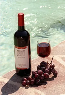 Food and Drink Bottle of Italian Red Wine from Umbria with Grapes and Glass Food and Drink Bottle of Italian Red Wine from Umbria with Grapes and Glass