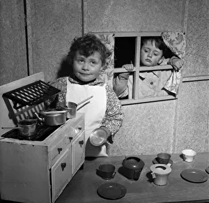 Four-year-old David McKnight and Jane Mathieson playing with their toy kitchen at Four-year-old David McKnight and Jane Mathieson playing with their toy kitchen at