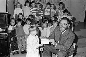 Images Dated 16th September 1986: Four-year-old Emily Sylvester presents a £300 cheque to National Society for