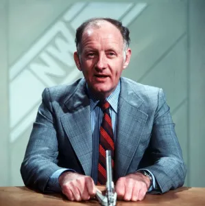 Frank Bough TV Presenter sitting at desk reading news Frank Bough TV Presenter sitting at desk reading news