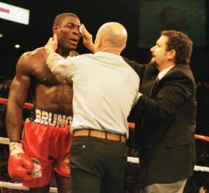 Frank Bruno gets attention at the end of the fight after his defeat in three Frank Bruno gets attention at the end of the fight after his defeat in three