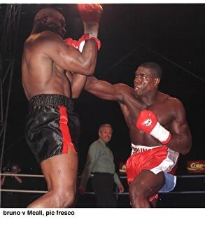 Images Dated 2nd September 1995: Frank Bruno strikes Oliver McCall with a right hook during their fight for