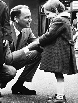 Frank Sinatra Actor and Singer talking to a little blind girl at his visit to Frank Sinatra Actor and Singer talking to a little blind girl at his visit to