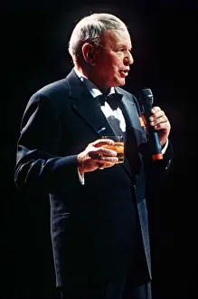 Frank Sinatra sings in concert with drink in hand Frank Sinatra sings in concert with drink in hand