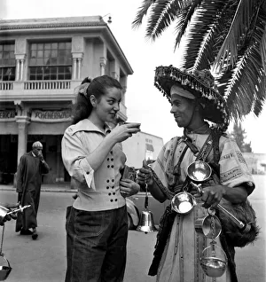 French actress buys a drink of water from a local vendor in the town of French actress buys a drink of water from a local vendor in the town of