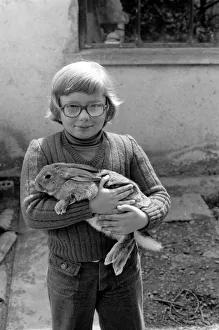 French schoolboy Jean Luc aged 8 with one of the families rabbits that will be due for French schoolboy Jean Luc aged 8 with one of the families rabbits that will be due for