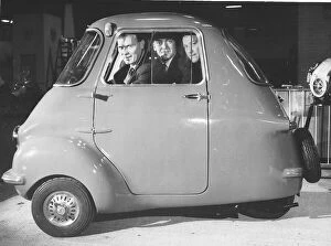 Motors Gallery: Three friends sit in a three wheeler Scootacar at the Earls Court Cycle and Motorshow