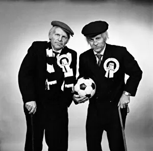 Images Dated 15th April 1975: Fulham footballers Bobby Moore (left) and Alan Mullery dressed in suits and make-up