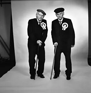 Images Dated 15th April 1975: Fulham footballers Bobby Moore (left) and Alan Mullery dressed in suits and make-up