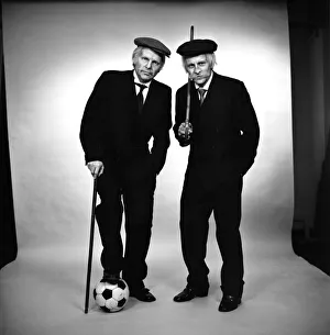 Images Dated 15th April 1975: Fulham footballers Bobby Moore (left) and Alan Mullery dressed in suits and make-up
