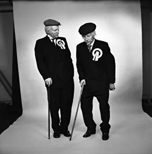 Images Dated 15th April 1975: Fulham footballers Bobby Moore (left) and Alan Mullery dressed in suits and make-up