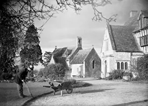 A gardener trims the edge of the front lawn at a country house. January 1935 A gardener trims the edge of the front lawn at a country house. January 1935