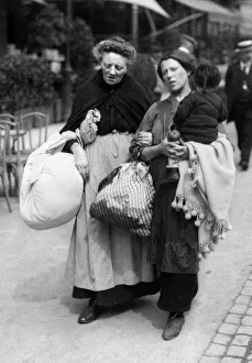 Three generations of refugees weary and footsore, they arrive in Brussels with such few Three generations of refugees weary and footsore, they arrive in Brussels with such few