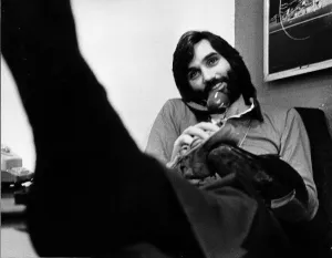 George Best in his office cleaning his shoes whilst chatting on the phone May 1974 George Best in his office cleaning his shoes whilst chatting on the phone May 1974