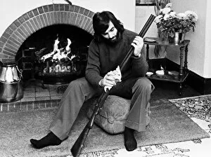 Images Dated 12th May 1974: George Best seen here cleaning his gun at home May 1974