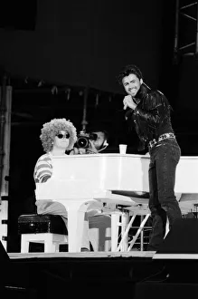 George Michael and Elton John, dressed as a clown, performing at the Wham George Michael and Elton John, dressed as a clown, performing at the Wham
