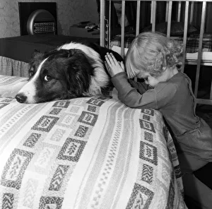 A girl and dog praying. 21st December 1954 A girl and dog praying. 21st December 1954