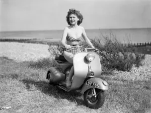 01239 Gallery: A girl on a Vespa motor scooter. 1952