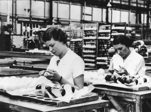 Girls covering the black case of the tennis balls with felt at the Dunlop Works in Girls covering the black case of the tennis balls with felt at the Dunlop Works in