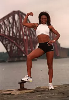Images Dated 30th June 1997: Gladiator Rocket (Pauline Richards) showing her muscles with the Forth railway bridge in