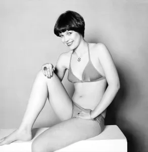 A glamour model posing wearing bikini and various items of jewellery including rings A glamour model posing wearing bikini and various items of jewellery including rings