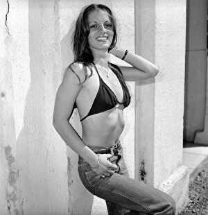 00069 Gallery: A glamour model wearing a bikini top and jeans April 1975