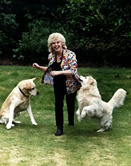 Gloria Hunniford TV Presenter in garden with dogs Gloria Hunniford TV Presenter in garden with dogs
