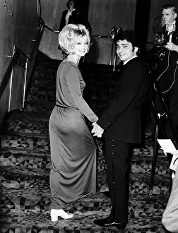 Goldie Hawn Actress holding hands with her husband Gus Trikonis at a film premiere in