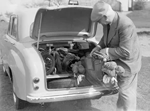 00573 Gallery: Golfer seen here storing his golf clubs in the boot of his brand new Standard 8 car Circa