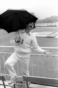 Graham Gooch England cricketer takes shelter from the rain under an umbrella as Graham Gooch England cricketer takes shelter from the rain under an umbrella as