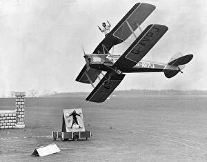 Images Dated 10th March 2008: Graham Tyson on the wings of the Tiger moth with a Colt 38 ready to shoot from a moving