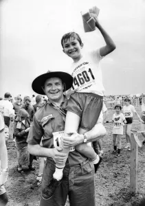 The Great North Run 27 June 1982 - Scout leader Glyn Bathgate hoists aloft one of his The Great North Run 27 June 1982 - Scout leader Glyn Bathgate hoists aloft one of his