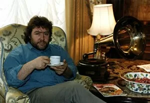 Gregor Fisher Actor Star of Rab C Nesbittsitting in chair drinking a cup of tea