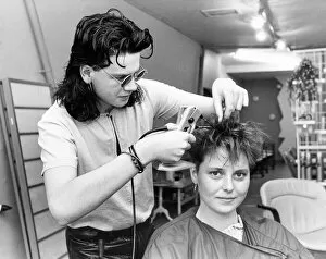 A hair dresser putting hair extensions in model Lisa Houghtons hair in July 1986