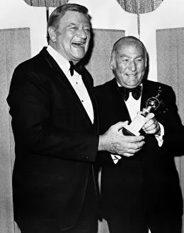 Hal Wallis film producer accepts Cecil B De Mille award 1975 from actor John Wayne