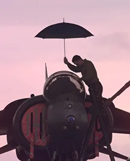 A harrier technician works on a weather grounded harrier at Gioia del Colle air base in A harrier technician works on a weather grounded harrier at Gioia del Colle air base in