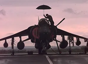 A harrier technician works on a weather grounded harrier at Gioia del Colle air base in A harrier technician works on a weather grounded harrier at Gioia del Colle air base in