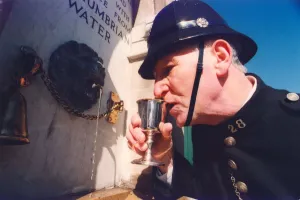 Harry Wynne dressed as a police sergeant from 1913 takes a drink from the newly installed Harry Wynne dressed as a police sergeant from 1913 takes a drink from the newly installed