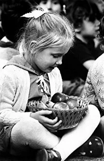 Harvest Festival. Four year old Rebecca Jamewake keeps a tight grip on a basket of
