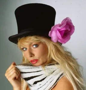 Hat Fashion model wears black top hat with lilac flower April 1990 Hat Fashion model wears black top hat with lilac flower April 1990