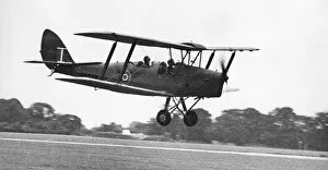 A de Havilland Tiger Moth landing on an airfiield. 02/07/1977