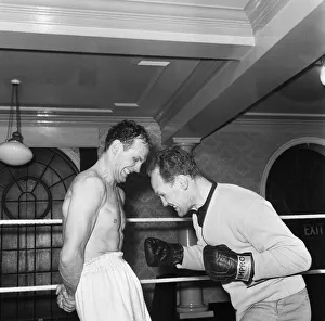 Having his stomach muscles strengthened is British Heavyweight Champion Henry Cooper Having his stomach muscles strengthened is British Heavyweight Champion Henry Cooper
