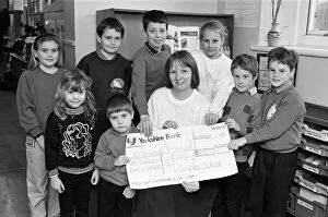 Images Dated 24th January 1992: Hilary Turner of Kirkwood Hospice receives £155. 75 cheque from children at Scholes